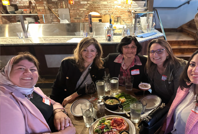 L to R: Rania Elsheikh, Mona Heredia, Priya Santhanam, Sara Nasshan, and Jaidaa Tahoun gather around one of the high-tops to keep the conversation going after the meeting.